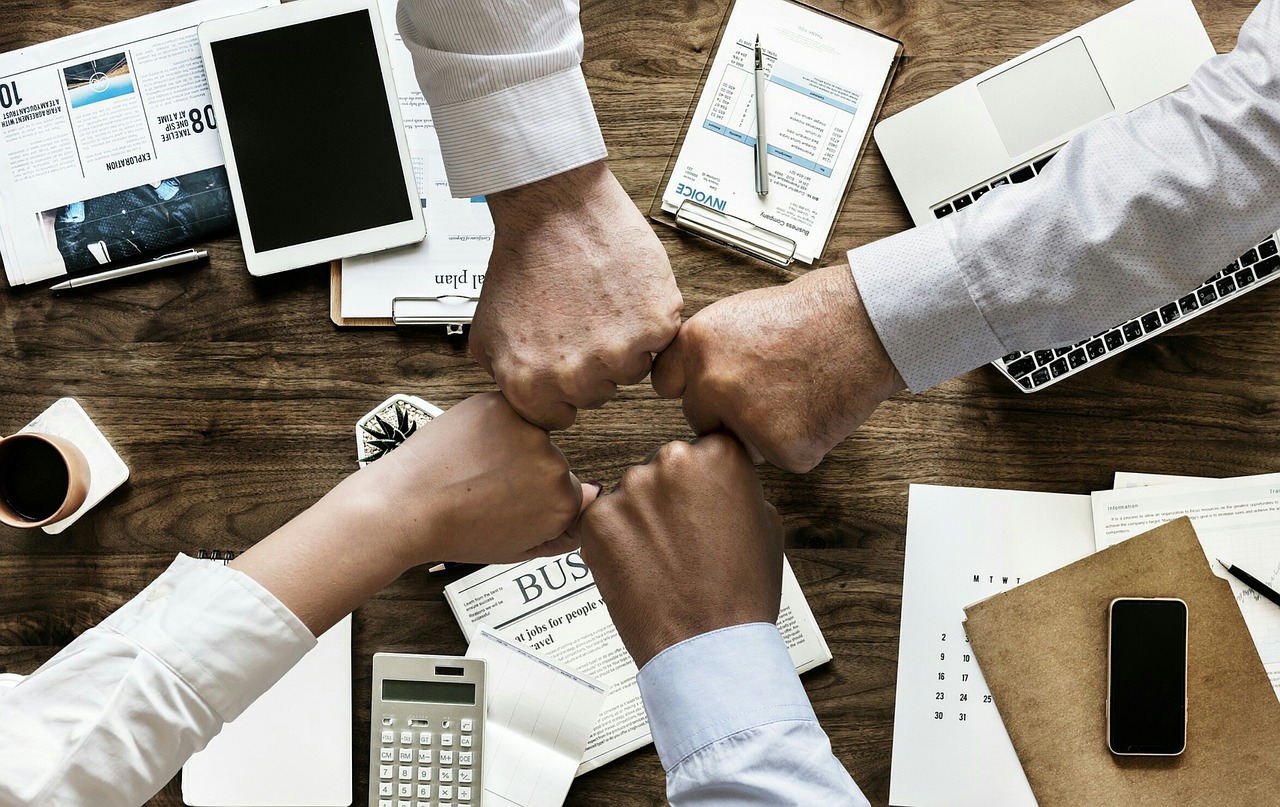 Business team fist bumping — partnership and collaboration